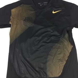 gold and black nike shirt